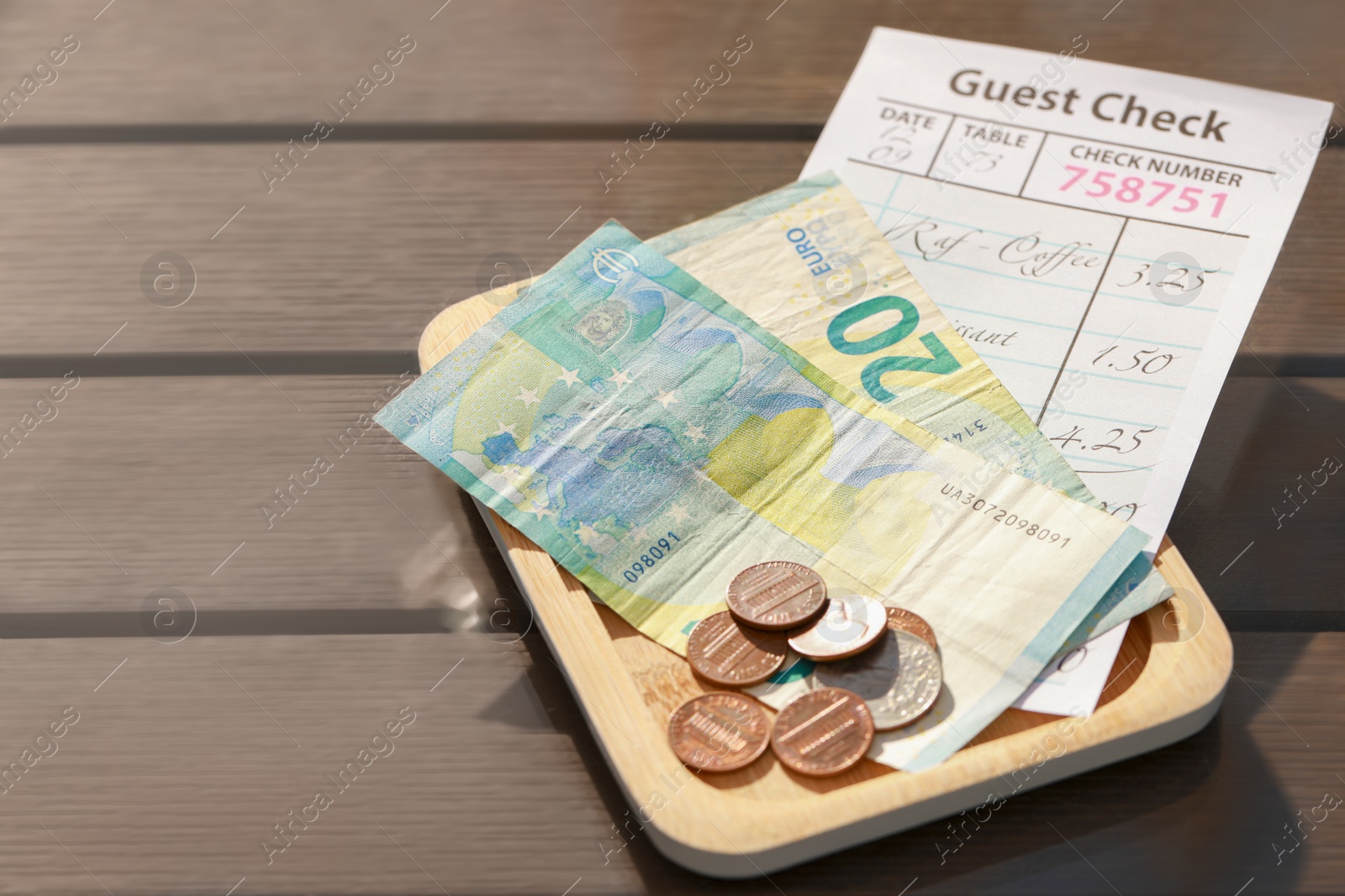 Photo of Wooden plate with payment for order and receipt on table, closeup. Leave tip