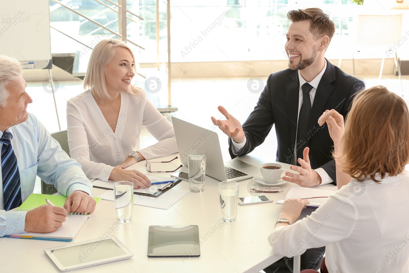 Photo of Group of people discussing ideas at table in office. Consulting service concept