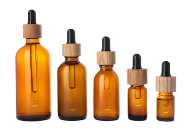 Row with different bottles of essential oil on white background