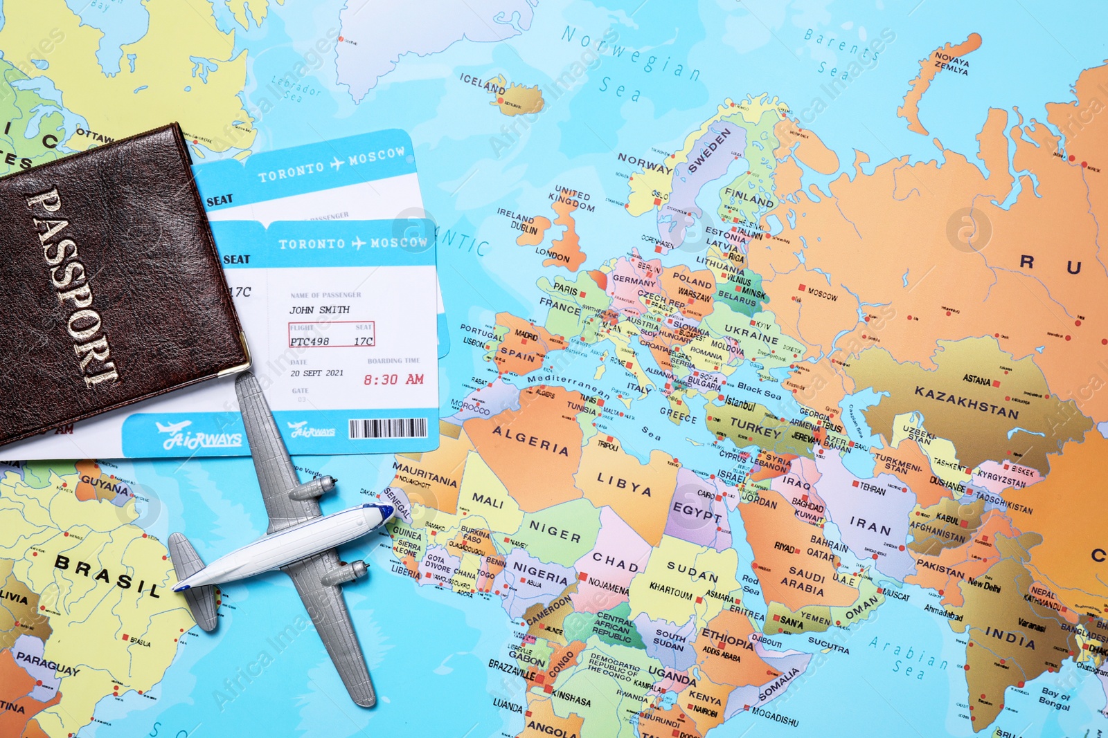 Photo of Toy airplane and passport with tickets on world map, flat lay. Space for text