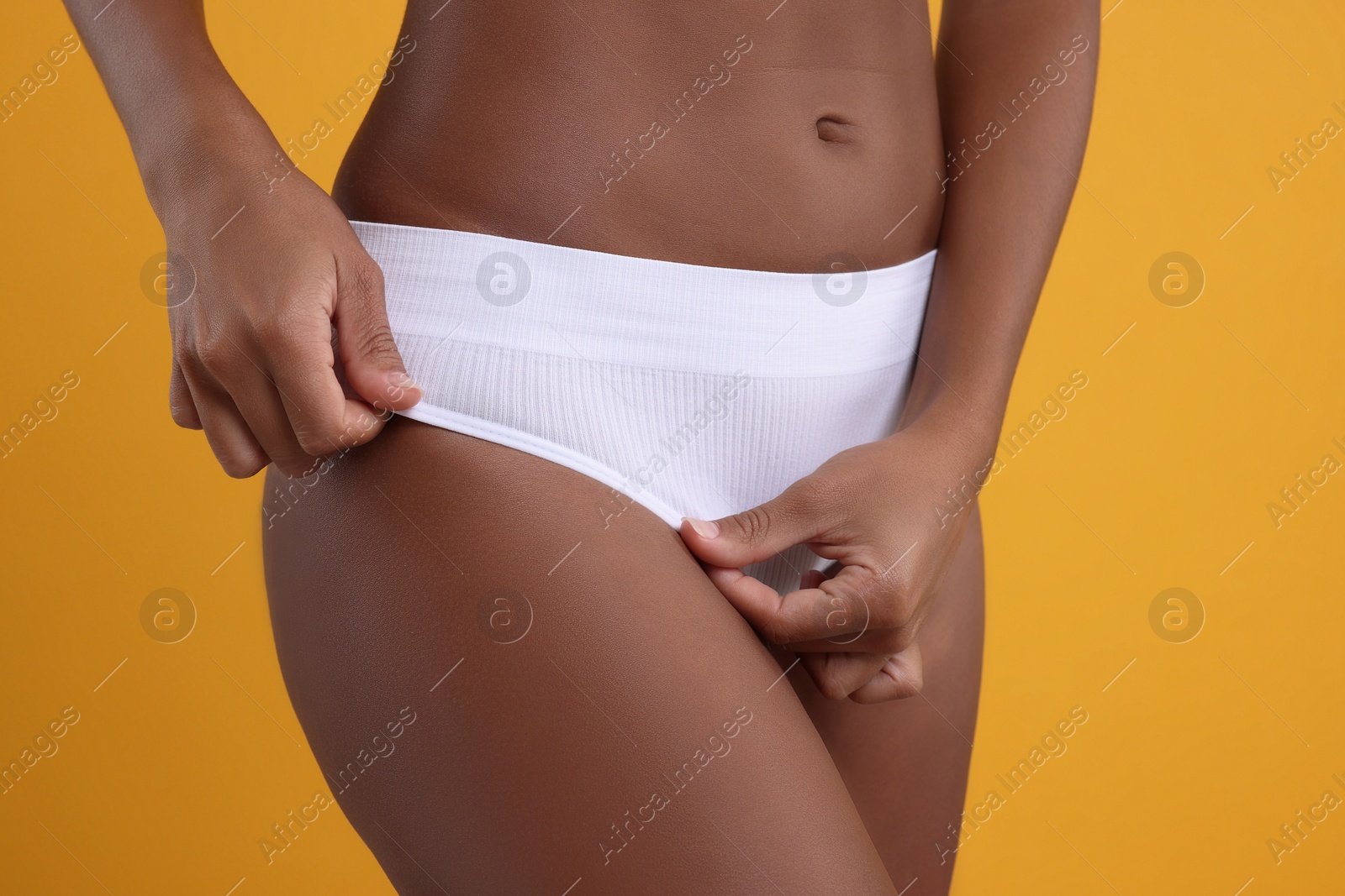 Photo of Woman in stylish bikini on yellow background, closeup