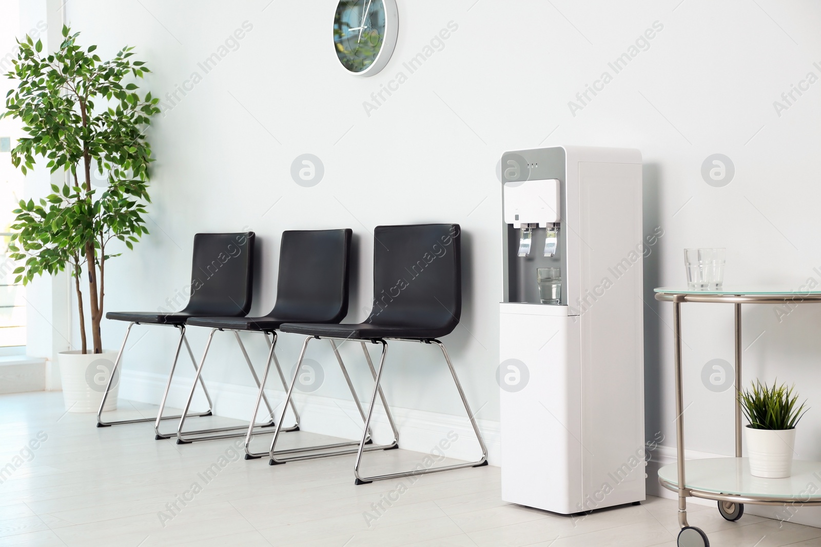 Photo of Modern water cooler in stylish office interior