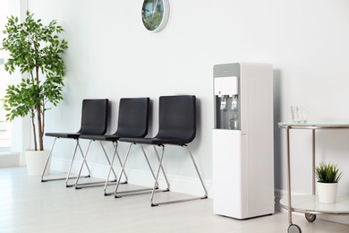 Modern water cooler in stylish office interior
