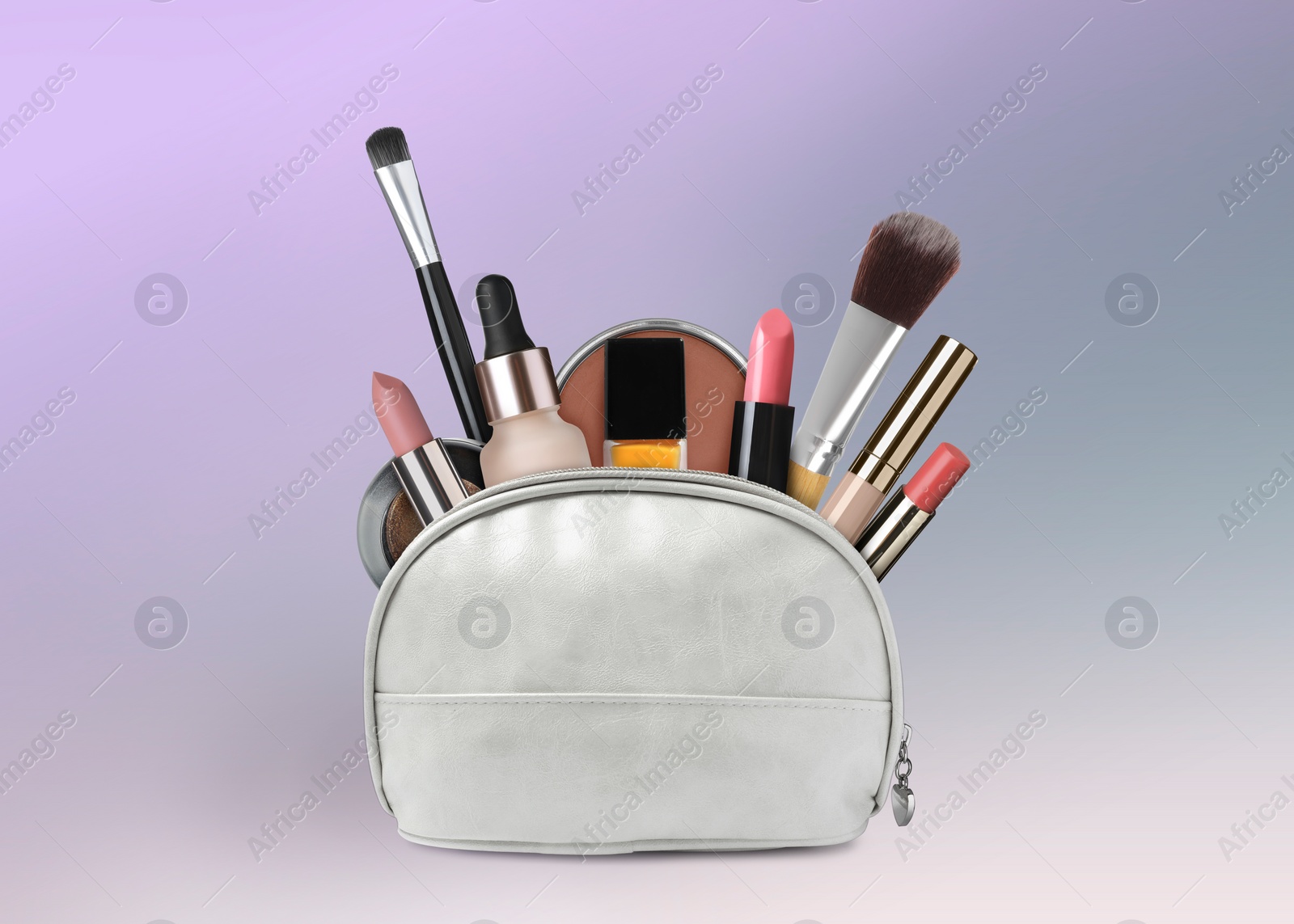 Image of Cosmetic bag filled with makeup products on color gradient background