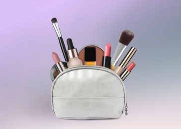 Image of Cosmetic bag filled with makeup products on color gradient background