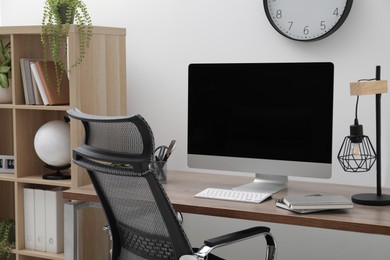 Photo of Workspace with desk, chair and computer at home