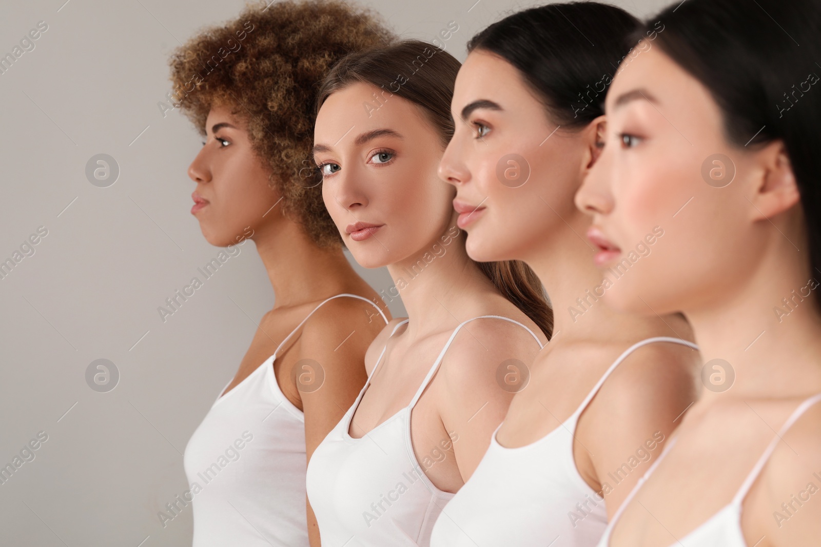 Photo of Beautiful young women with healthy skin on gray background