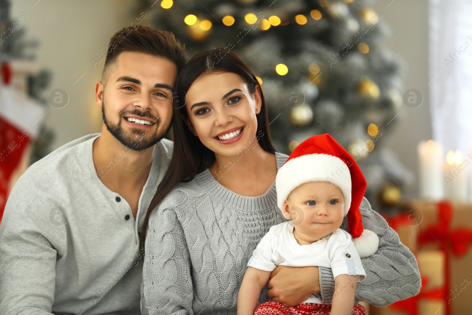 Photo of Happy family with cute baby at home. Christmas celebration