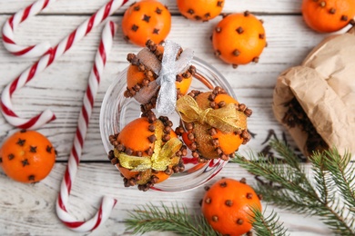 Photo of Flat lay composition with tangerine pomander balls on white wooden table