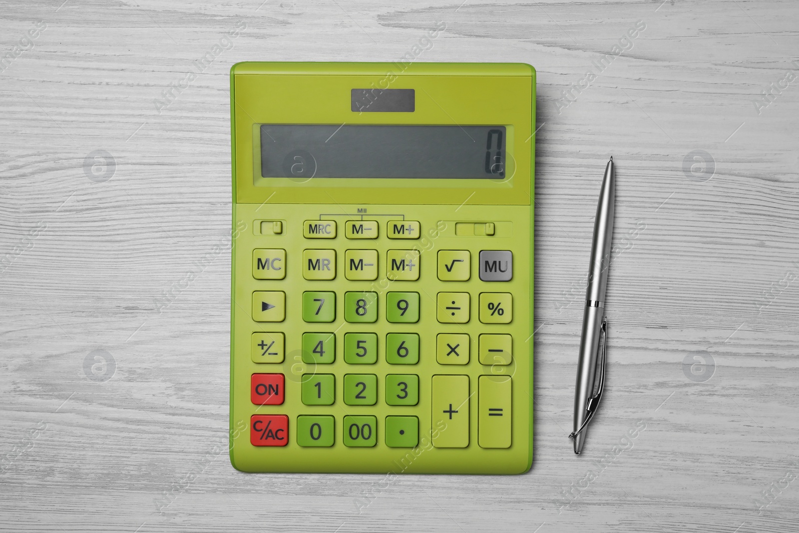 Photo of Calculator and pen on white wooden table, top view