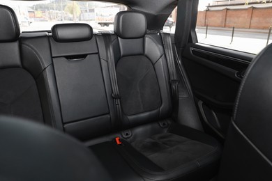 Clean leather seats inside of modern black car