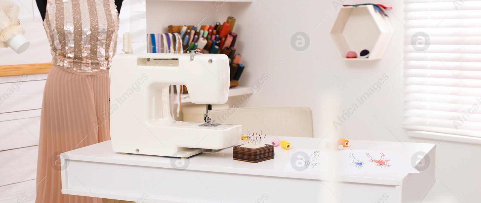 Image of Dressmaking workshop interior with sewing machine, mannequin and other equipment. Banner design