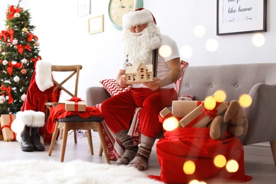 Photo of Authentic Santa Claus making toy in workshop