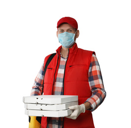 Photo of Courier in protective mask and gloves holding pizza boxes on light background. Food delivery service during coronavirus quarantine