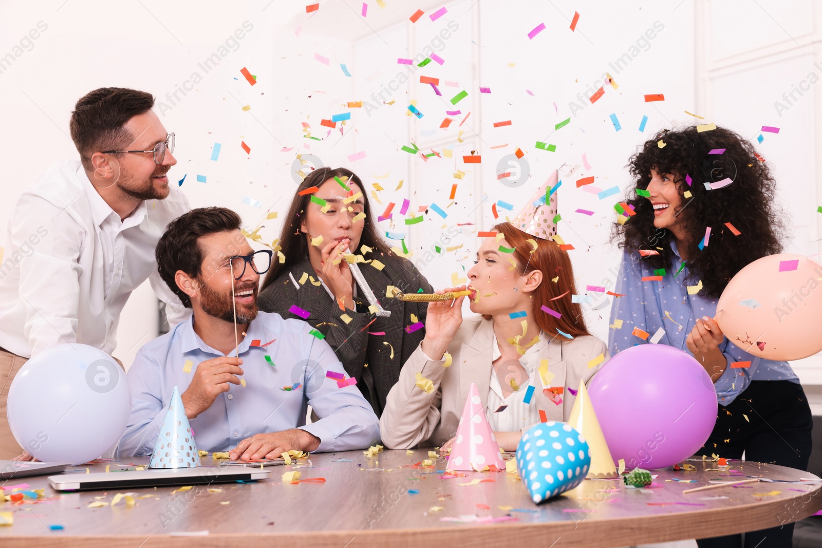 Photo of Coworkers having fun during office party indoors