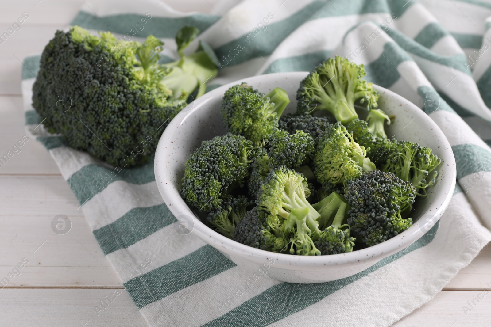 Photo of Fresh raw broccoli on white wooden table