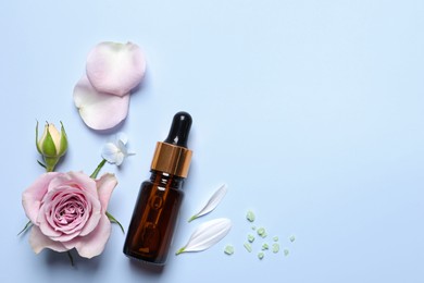 Bottle of cosmetic serum, beautiful flowers and sea salt on light blue background, flat lay