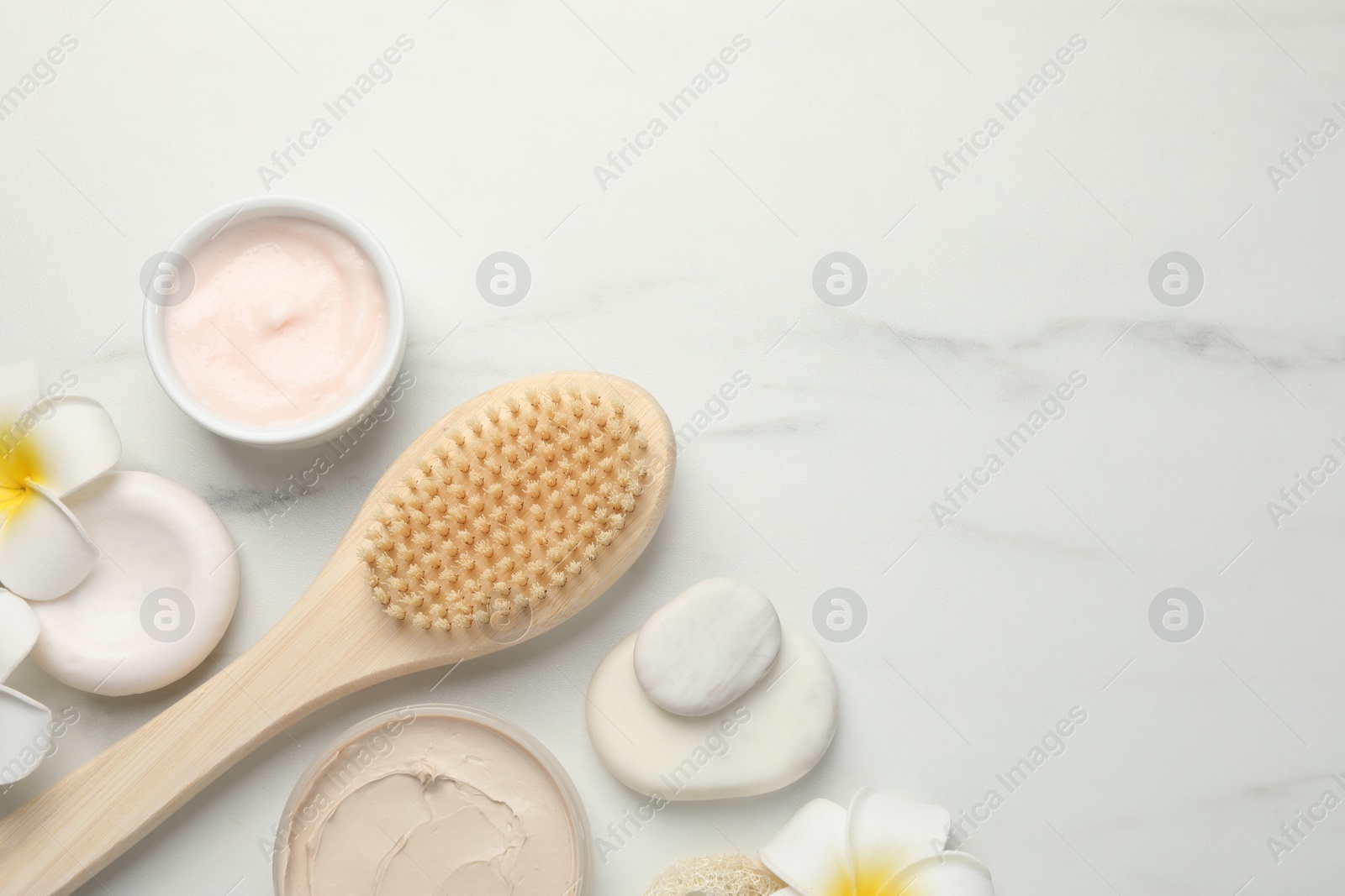 Photo of Flat lay composition with different spa products on white marble table. Space for text