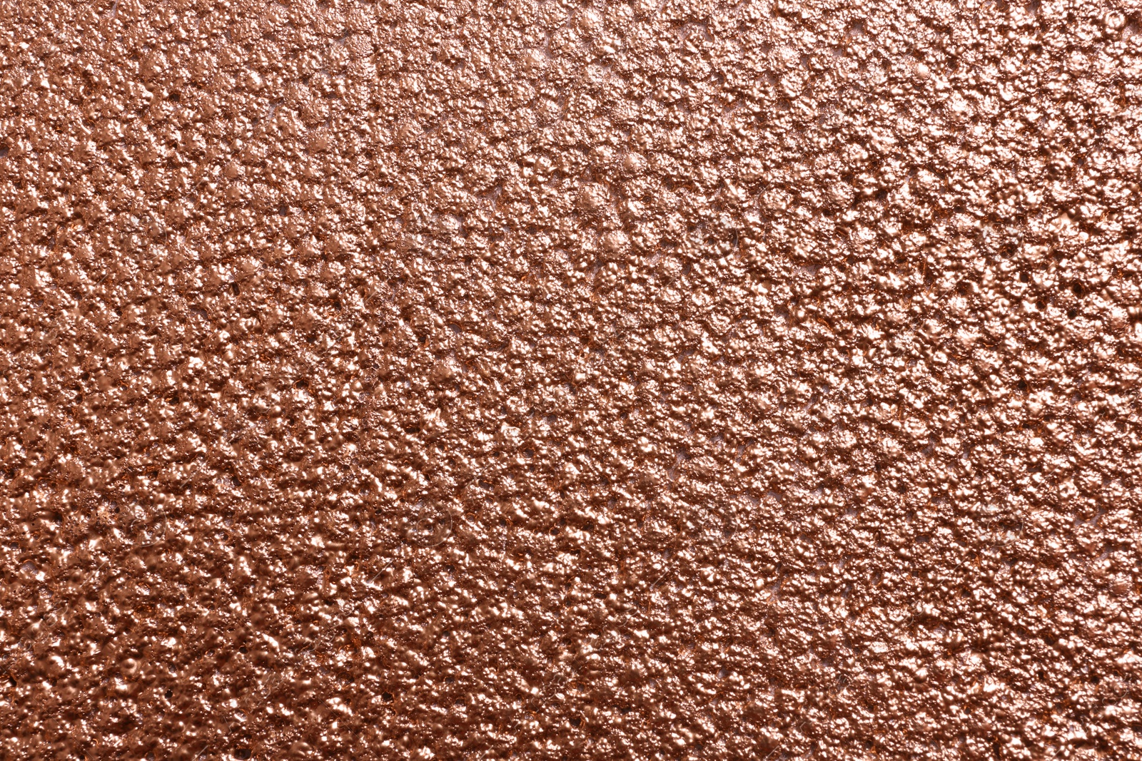 Photo of Rough rose gold surface as background, top view