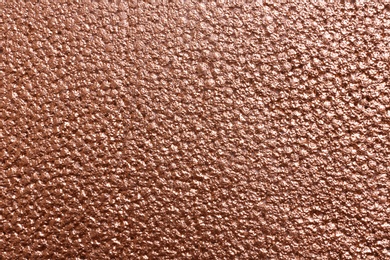 Photo of Rough rose gold surface as background, top view