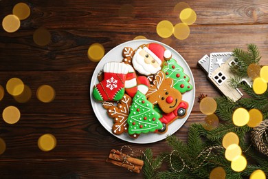 Different tasty Christmas cookies and decor on wooden table, flat lay. Space for text