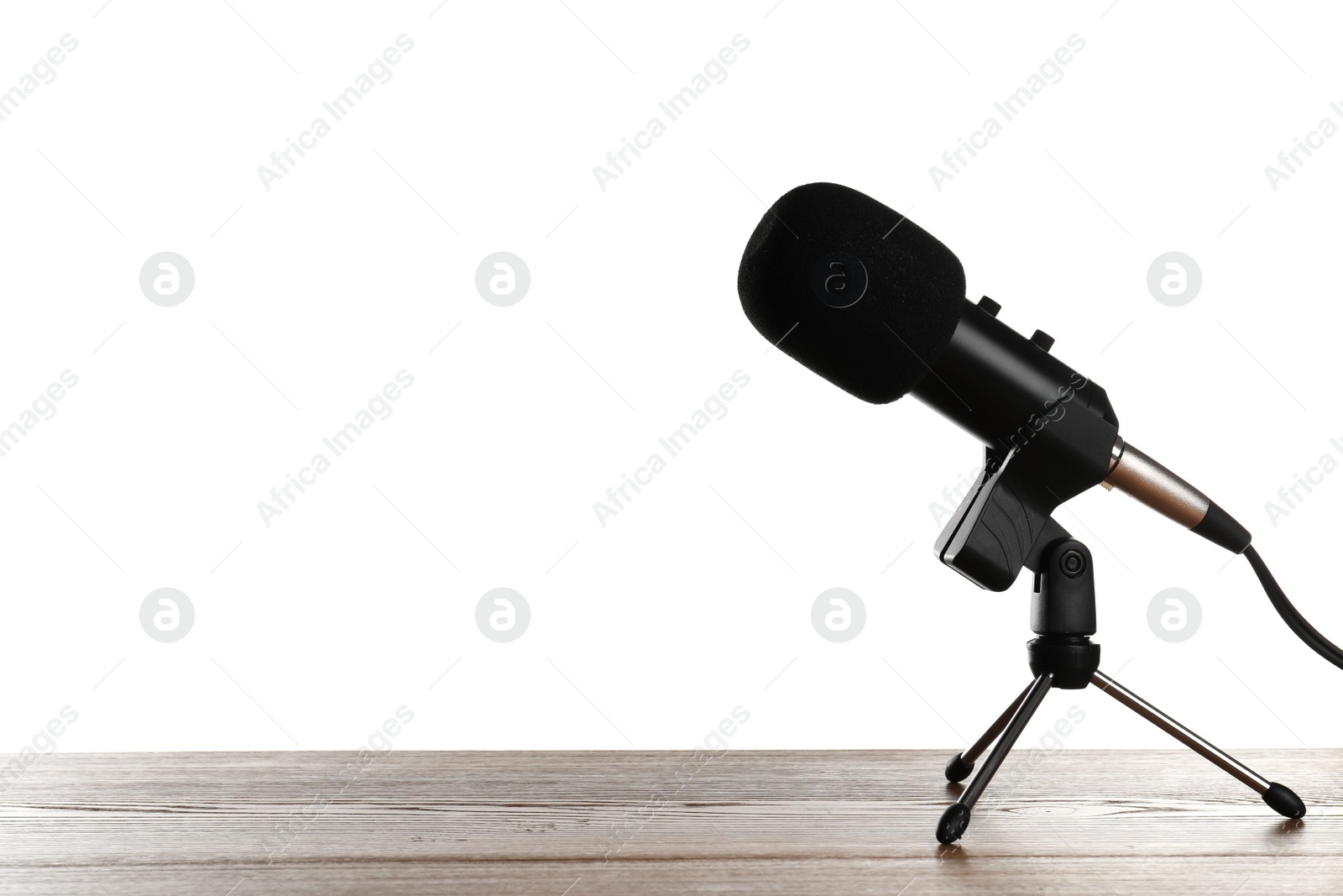 Photo of Microphone on table against white background. Space for text