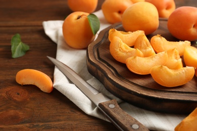 Composition with delicious ripe sweet apricots on wooden table, space for text