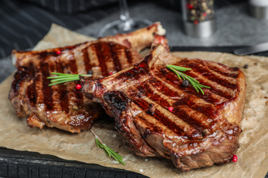 Photo of Delicious beef steaks served on table, closeup