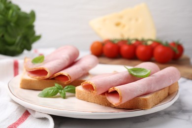 Photo of Delicious sandwiches with ham on white table, closeup