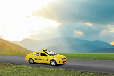 Image of Yellow taxi car on asphalt highway outdoors 