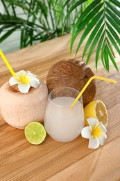 Composition with glass of coconut water on wooden table