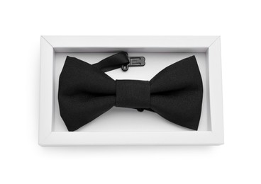 Stylish black bow tie on white background, top view