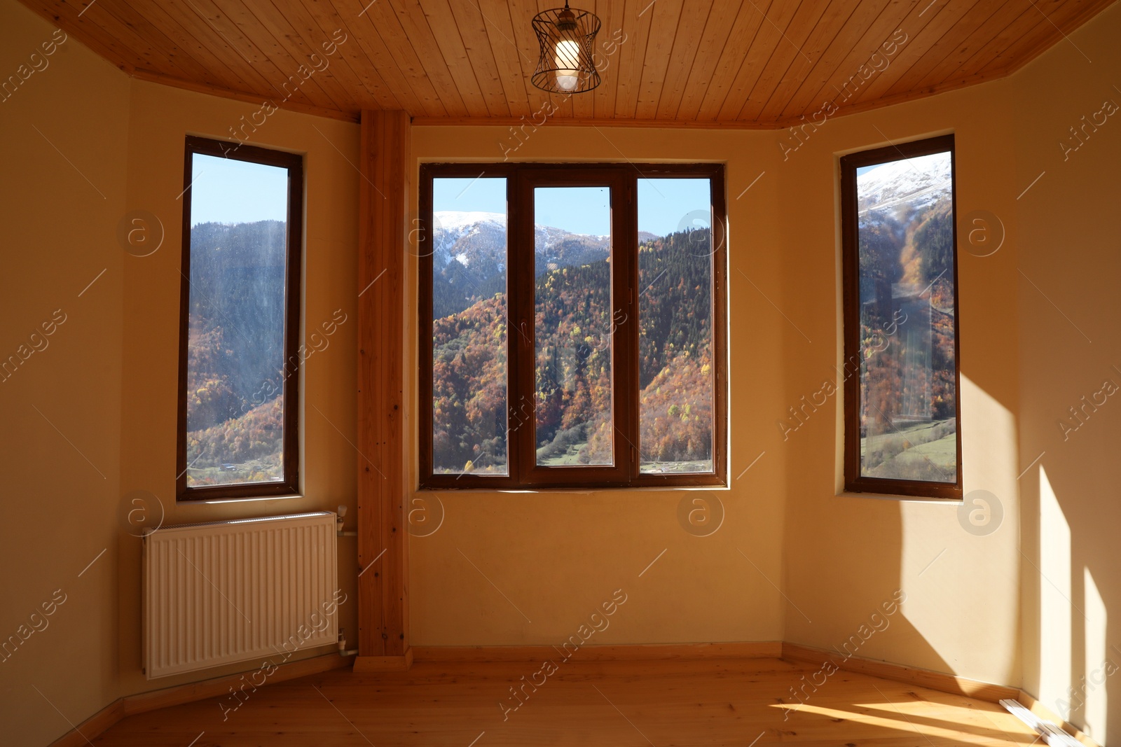 Photo of Empty room with clean windows and beige wall indoors