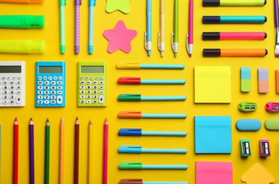 Photo of Flat lay composition with school stationery on yellow background. Back to school