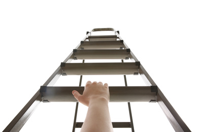 Woman climbing up stepladder on white background, low angle view