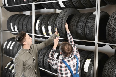 Photo of Service center consultant helping customer to choose tire in store