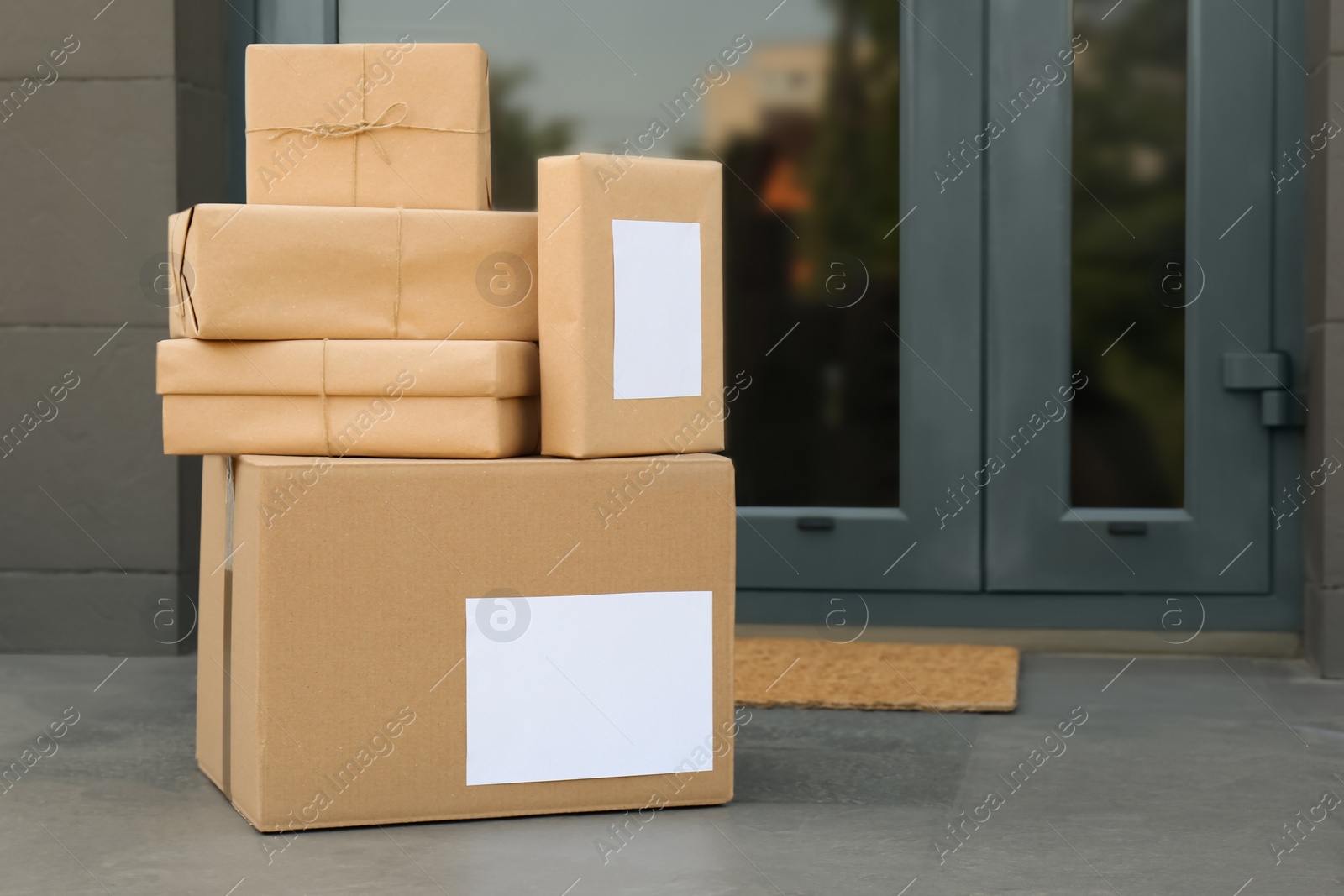 Photo of Cardboard boxes near door. Parcel delivery service