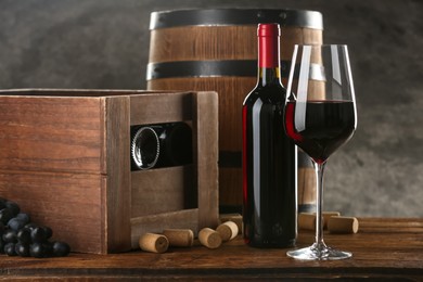 Winemaking. Composition with tasty wine and barrel on wooden table