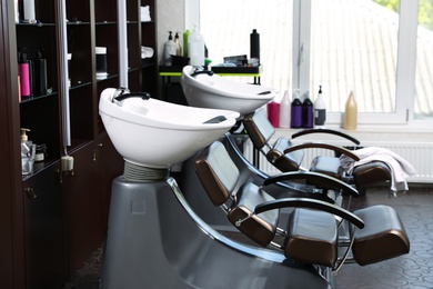 Photo of Modern hairdressing salon interior with professional equipment