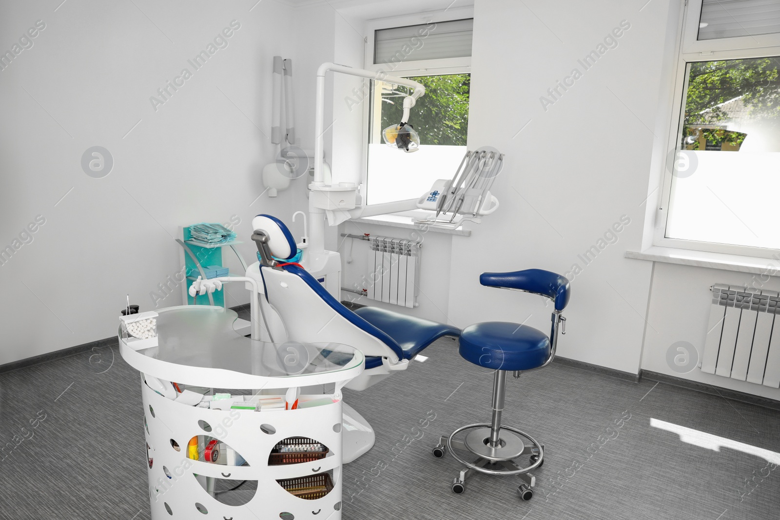 Photo of Dentist's office interior with modern chair and equipment