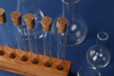 Different laboratory glassware on blue background, closeup