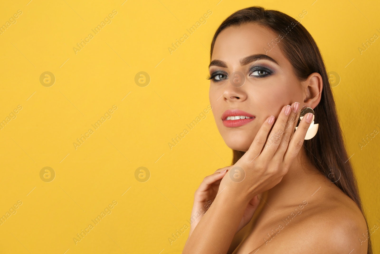 Photo of Portrait of beautiful woman with stylish makeup on color background. Space for text