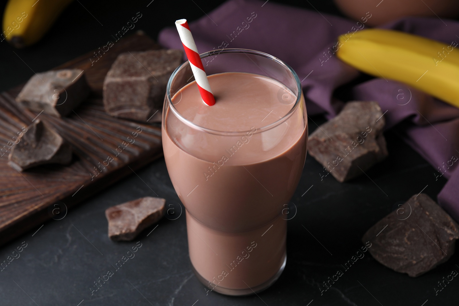 Photo of Fresh yummy chocolate milk on black table