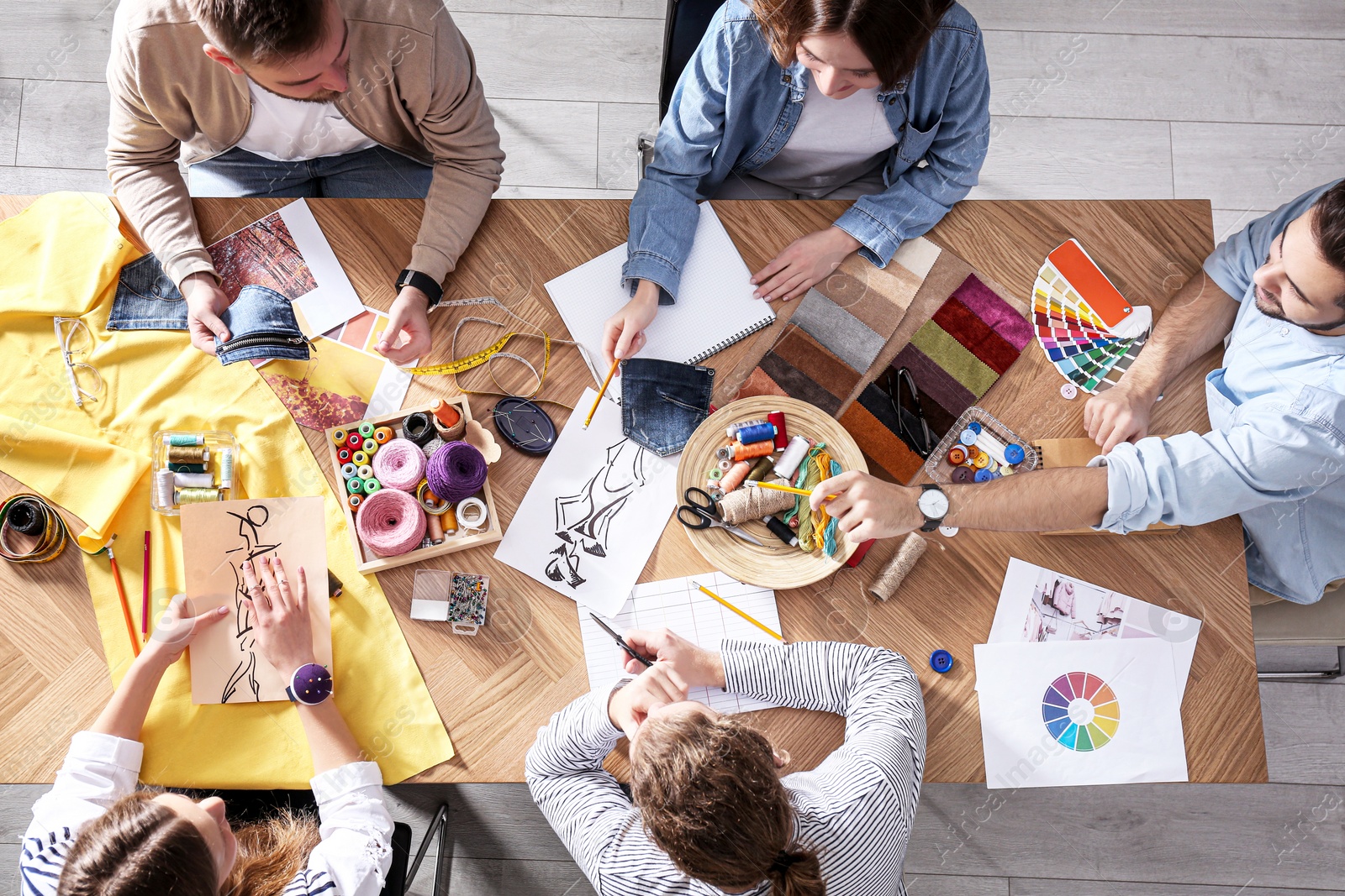 Photo of Fashion designer creating new clothes in studio, top view