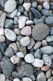 Many different pebbles as background, top view