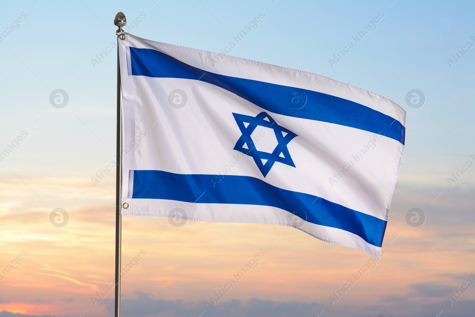 Image of National flag of Israel against blue sky with clouds