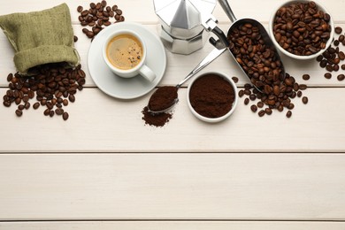 Coffee maker, beans, powder and cup of drink on white wooden table, flat lay. Space for text
