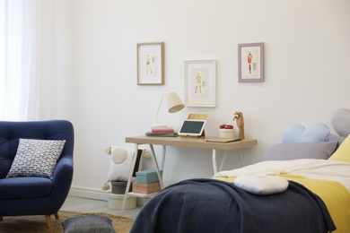 Photo of Modern teenager's room interior with bed and armchair