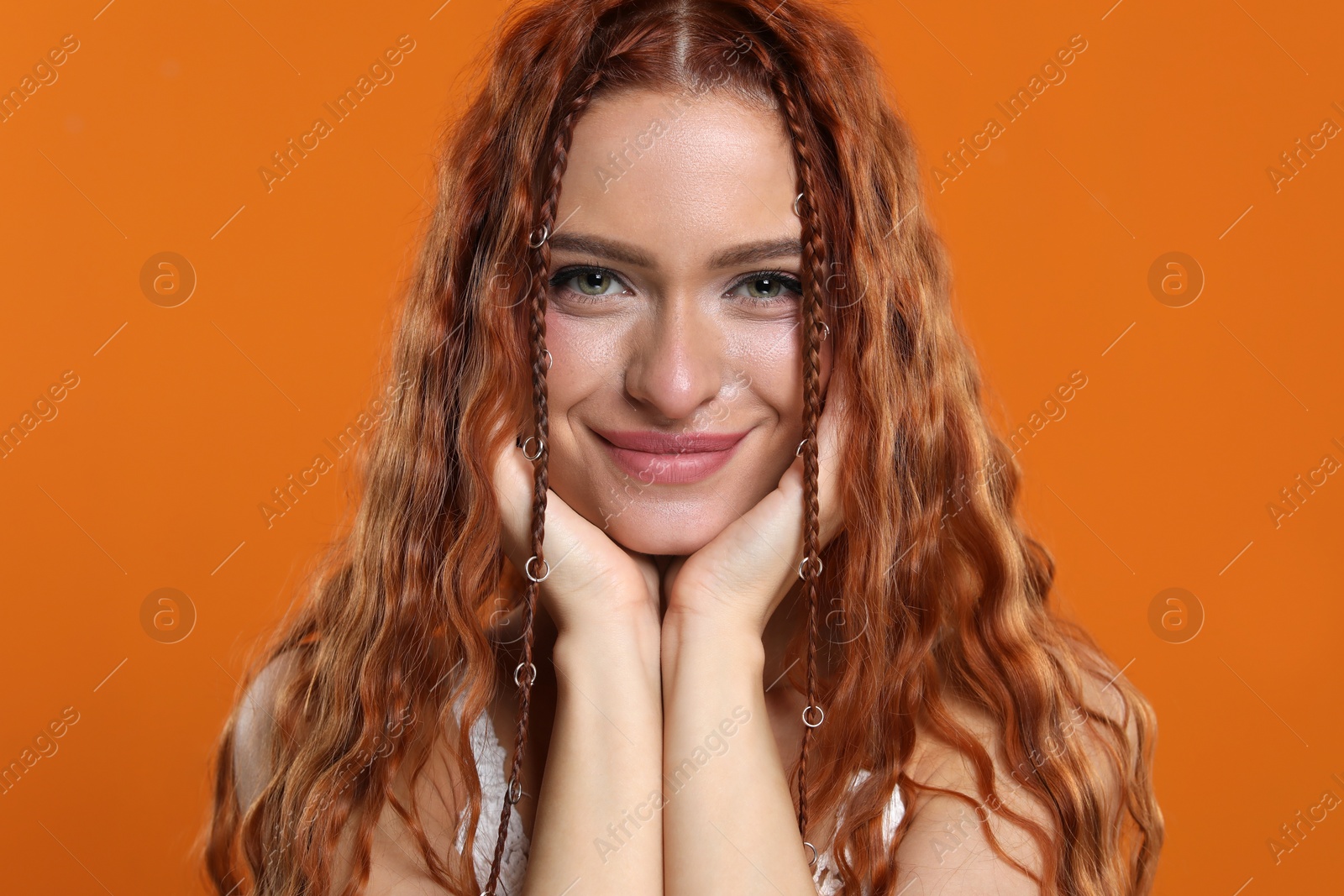 Photo of Beautiful young hippie woman on orange background