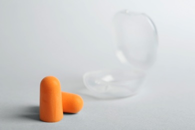 Photo of Pair of orange ear plugs on white background. Space for text
